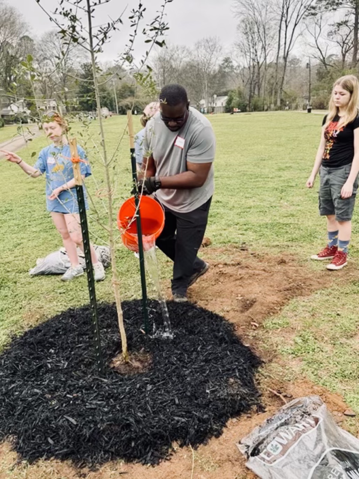 The next generation helps plant Crestline’s future canopy.